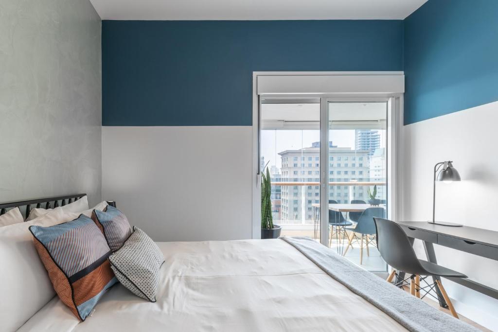 Cama ou camas em um quarto em Charlie One Eleven Vila Olímpia