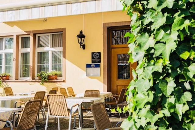 a group of tables and chairs in front of a building at Hotel Rössli in Basel