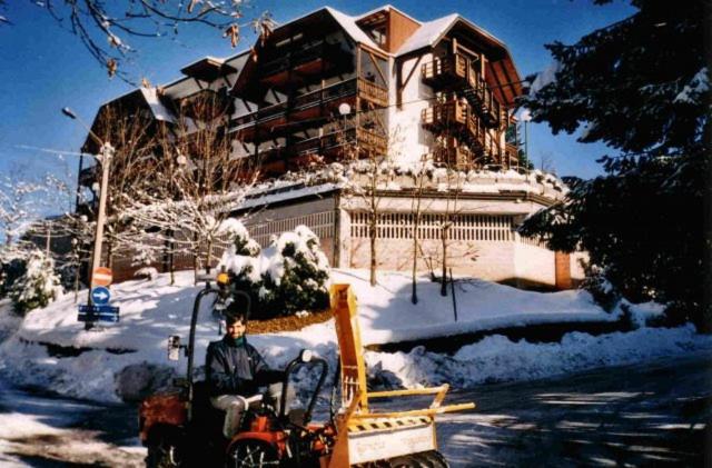 a man in a snow plow in front of a house at Bilocale Gran Chalet Montecreto in Montecreto