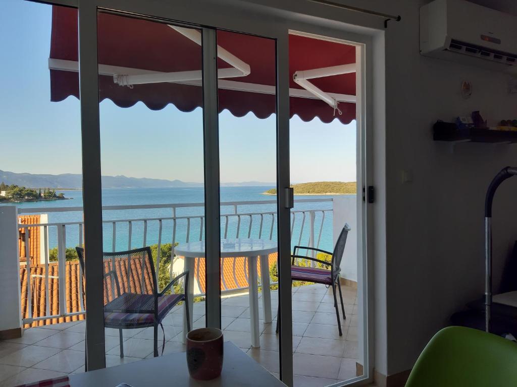 a room with a balcony with a view of the ocean at Blue sea blue sky in Lovište