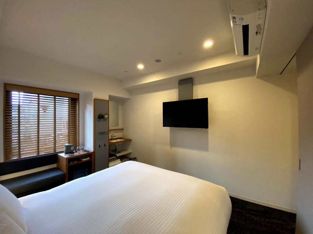 TV a/nebo společenská místnost v ubytování UMEDAHOLIC HOTEL