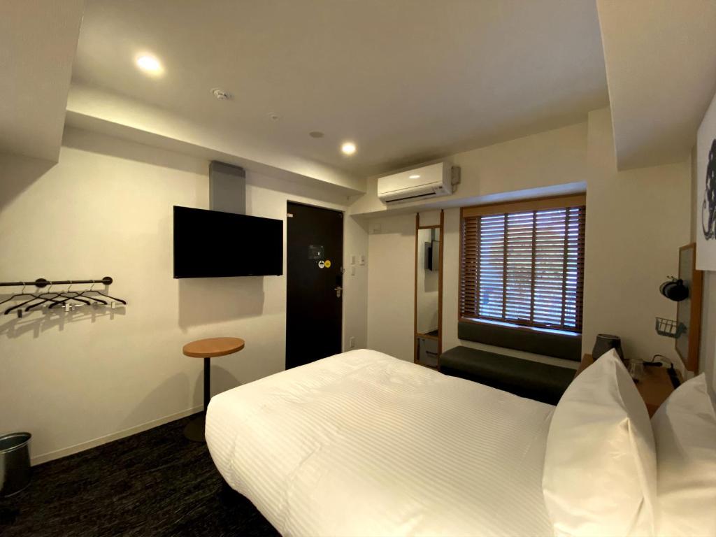 TV a/nebo společenská místnost v ubytování UMEDAHOLIC HOTEL