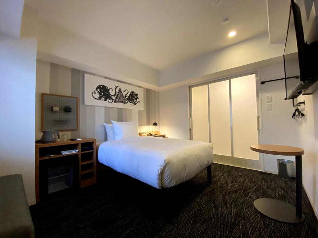 Postel nebo postele na pokoji v ubytování UMEDAHOLIC HOTEL