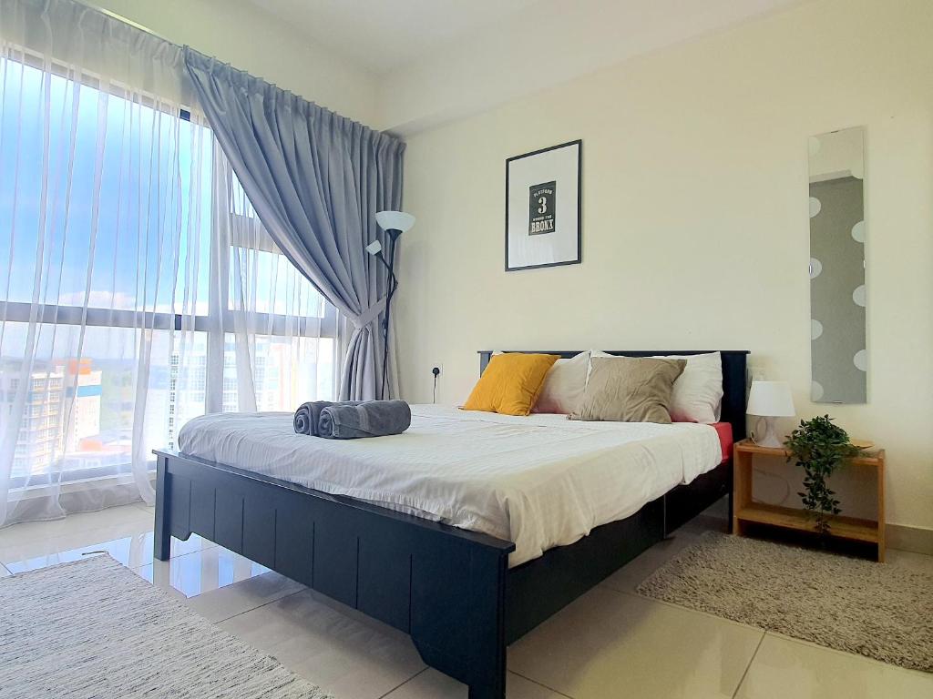 a bedroom with a bed with a large window at HYVE SOHO Cyberjaya by BeeStay Management in Cyberjaya