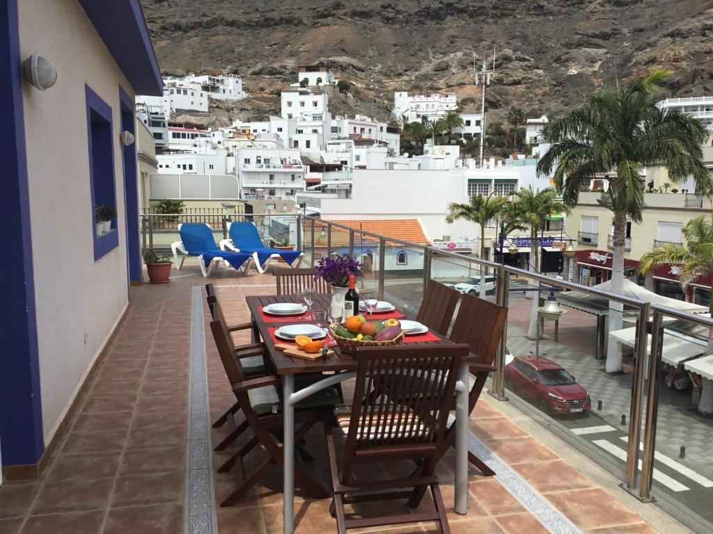 a balcony with a table and chairs and a view at BEACH SIDE in Puerto de Mogán