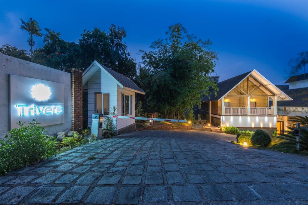 a driveway in front of a house at night at Trivers Resort Munnar in Munnar