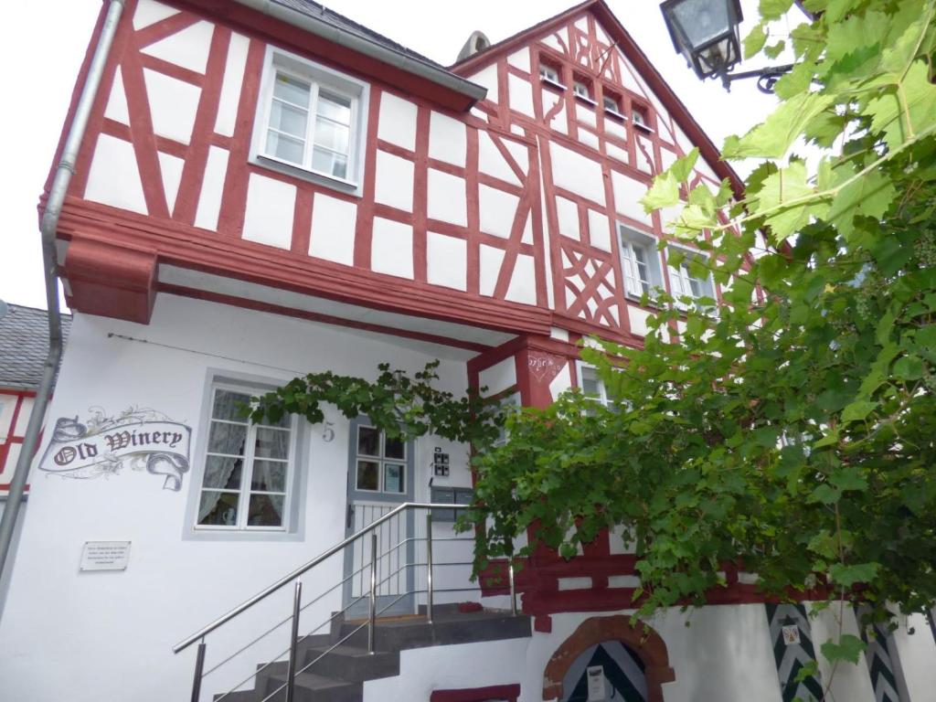 una casa con un edificio rojo y blanco en Ferienhaus Old Winery, en Briedel
