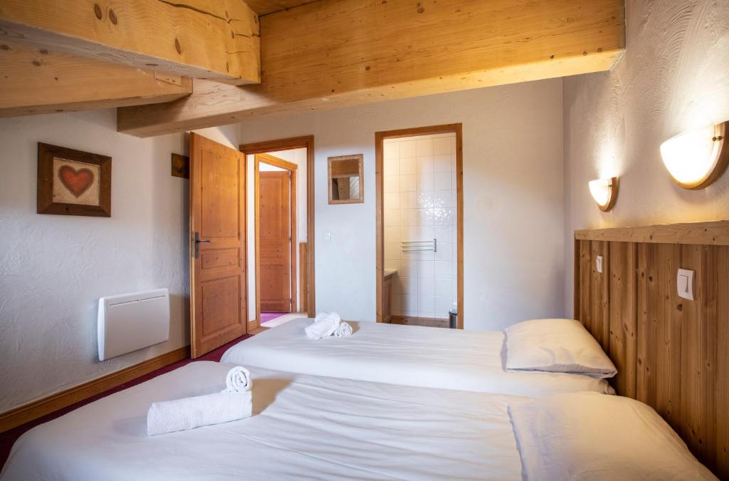 Postel nebo postele na pokoji v ubytování Chalet des Neiges Plein Sud