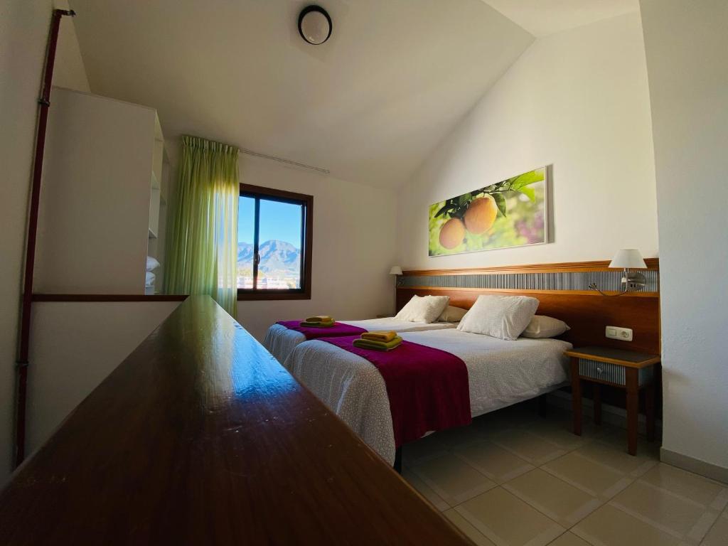 プラヤ・デ・ラス・アメリカスにあるCoral Compostela Beach, private apartmentのベッドと窓が備わるホテルルーム