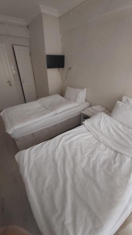 Postel nebo postele na pokoji v ubytování Dilmac Hotel