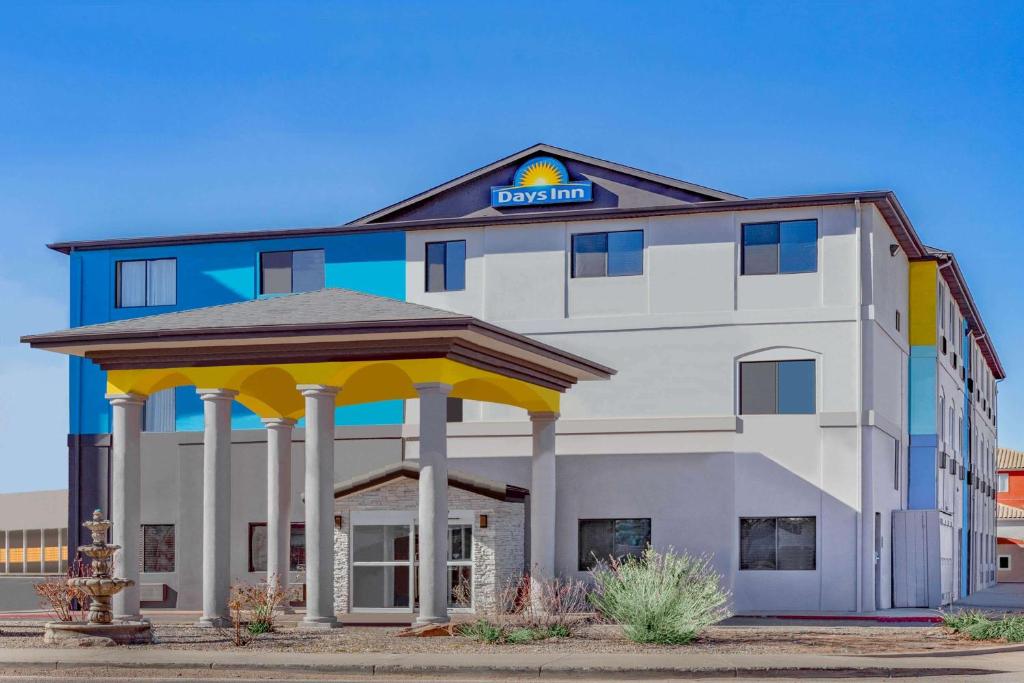 a hotel building with a gazebo in front of it at Days Inn by Wyndham Bernalillo in Bernalillo