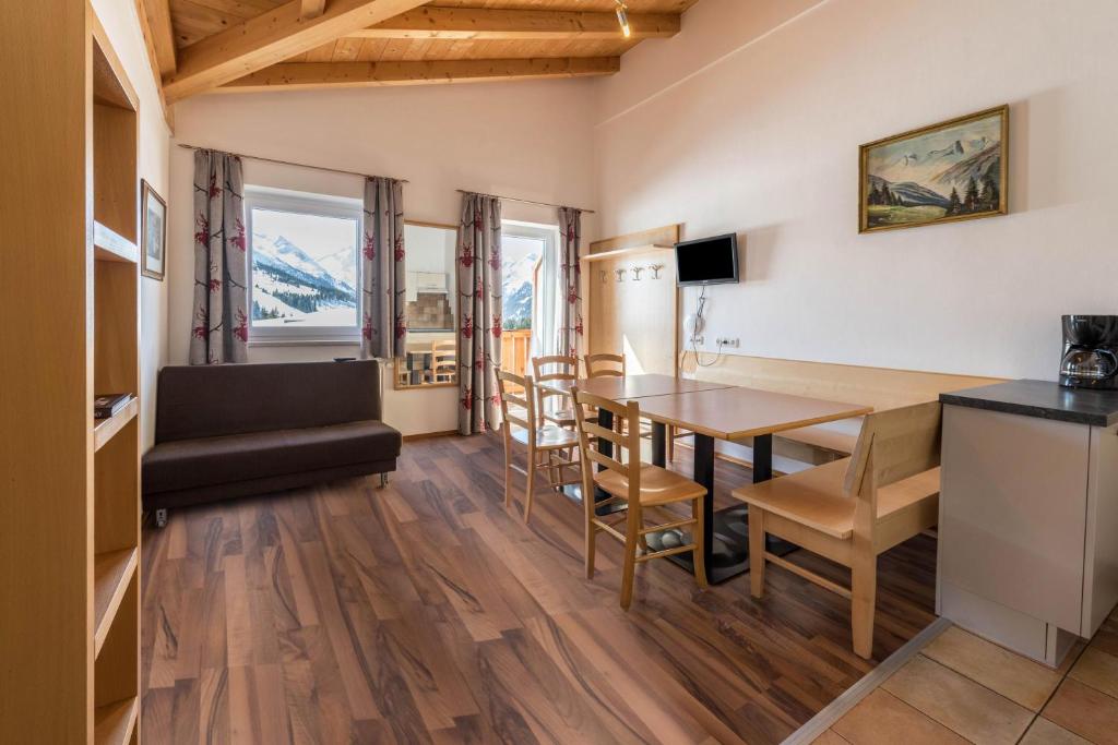 a kitchen and dining room with a table and chairs at Chalet Central - Top Cc8 in Königsleiten