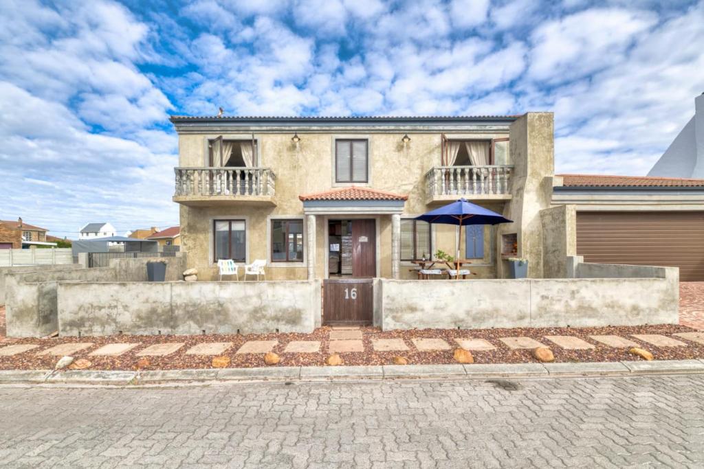 a house with a brick driveway in front of it at Catch of the Day in Struisbaai