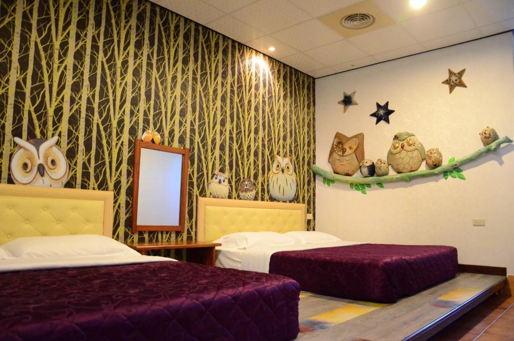 a hotel room with two beds and a mirror at Family Pottery in Hengchun South Gate