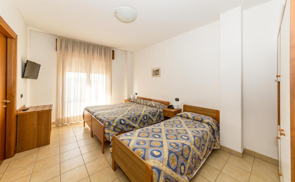 Postel nebo postele na pokoji v ubytování Hotel Alla Rotonda