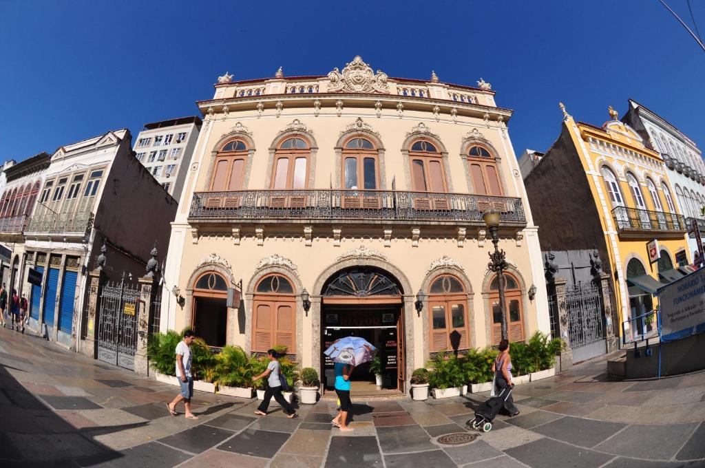 a group of people walking in front of a building at Hotel Plaza Riazor in Rio de Janeiro