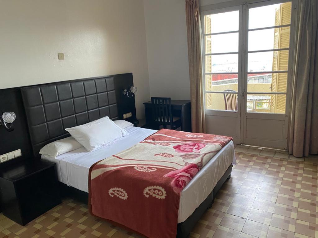 Letto o letti in una camera di Hotel Le Gardenia (ex Lutetia)