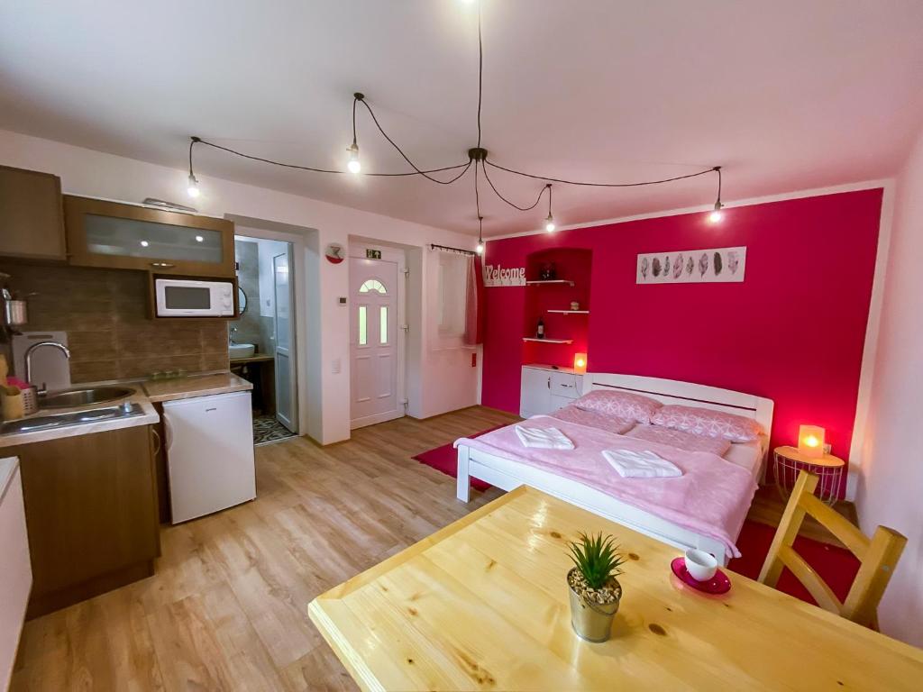 PačirにあるJulia Apartmanのリビングルーム(ベッド1台、テーブル付)
