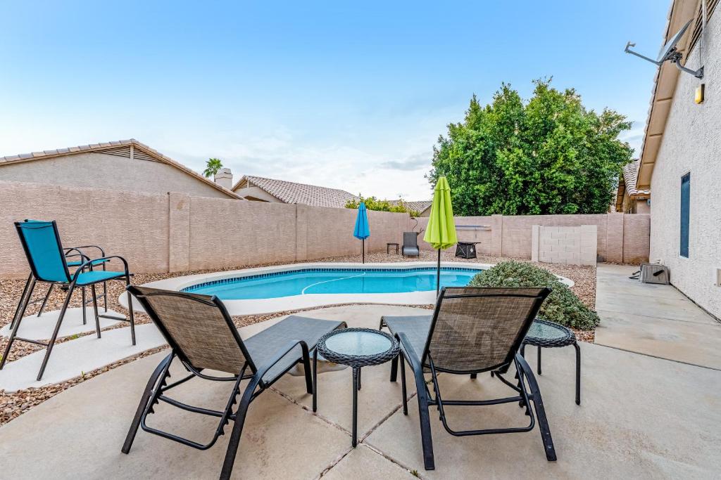 a patio with a table and chairs and a pool at Topeka Tops in Phoenix