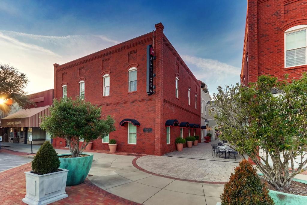 a red brick building with a clock tower at The Mantissa Hotel in Hartsville