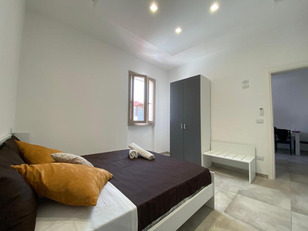 1 dormitorio con 1 cama con armario negro en Cattleya Holidays Apartment, en Porto Cesareo