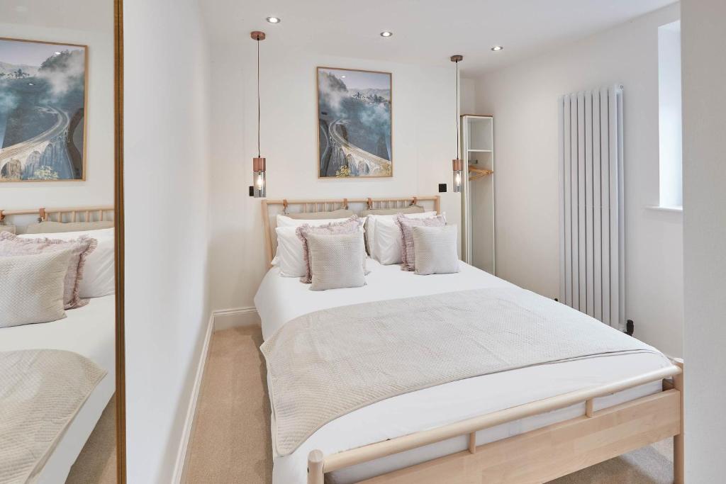 a bedroom with two beds with white walls at Host & Stay - Abbey Hus in Whitby