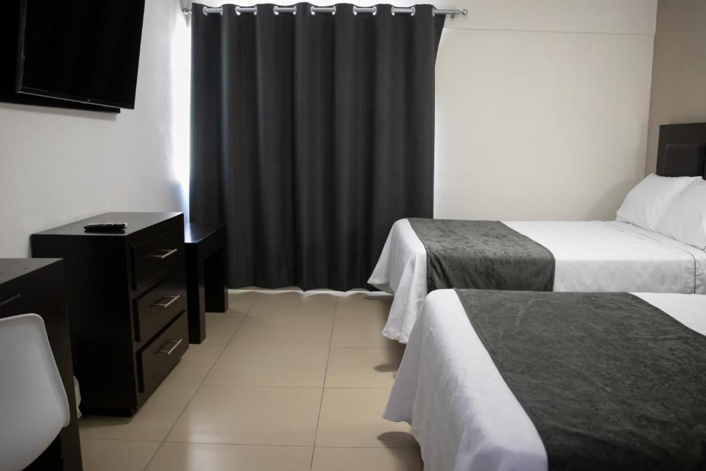 Postel nebo postele na pokoji v ubytování Hotel Las Pergolas