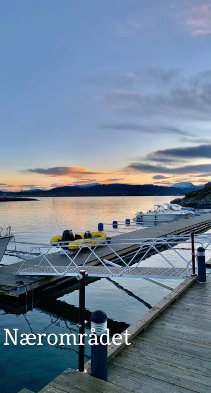 a dock with a boat on the water at Kronborg marina in Averoy