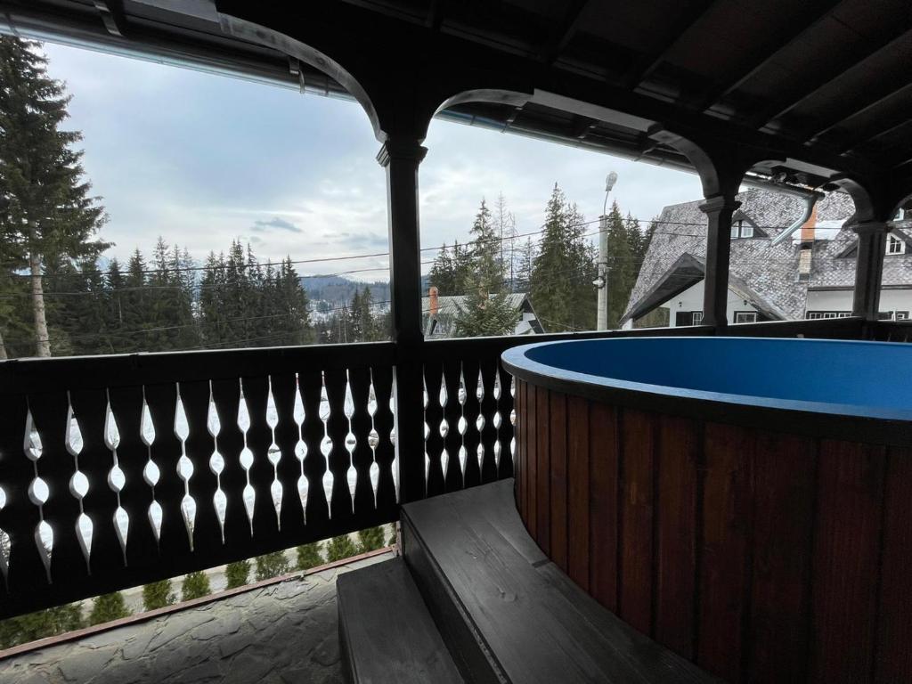 a hot tub on the deck of a house at Vila Sofia in Predeal