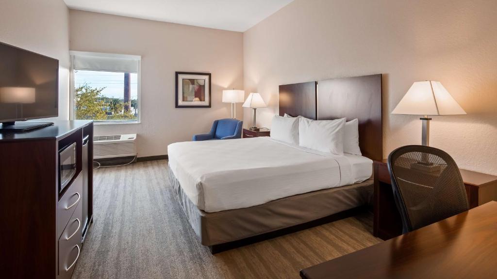 a hotel room with a bed and a television at Best Western Tampa in Tampa
