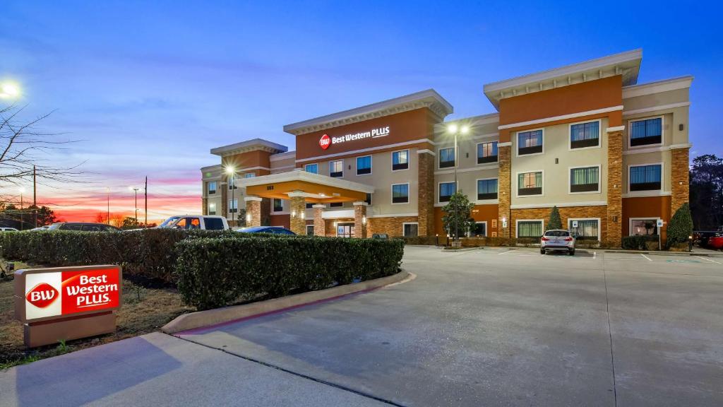 a hotel with a sign in front of a parking lot at Best Western Plus Spring Inn & Suites in Spring