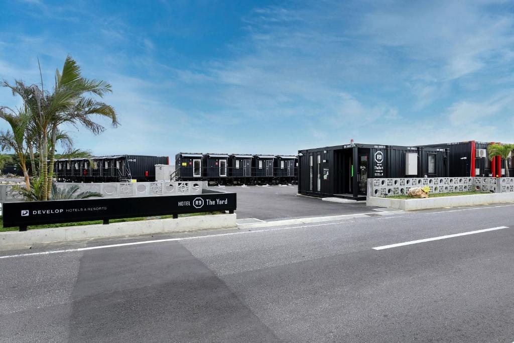 a row of black containers on the side of a road at HOTEL R9 The Yard Miyakojima in Miyako Island