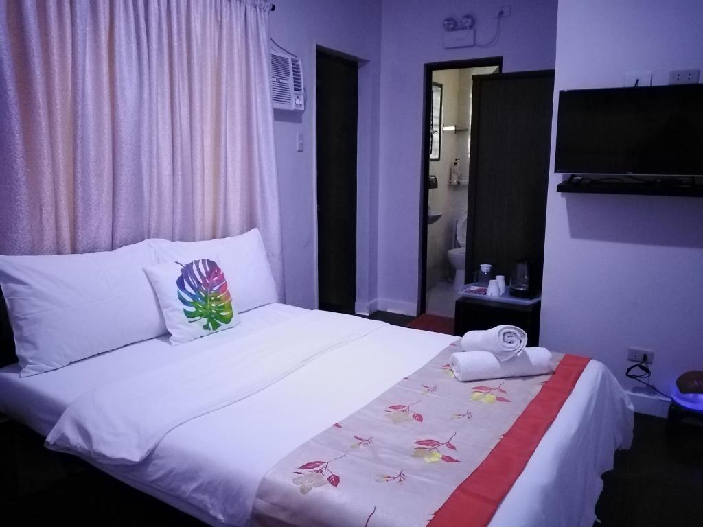Postel nebo postele na pokoji v ubytování HalfWay House Hostel Mactan Cebu Airport