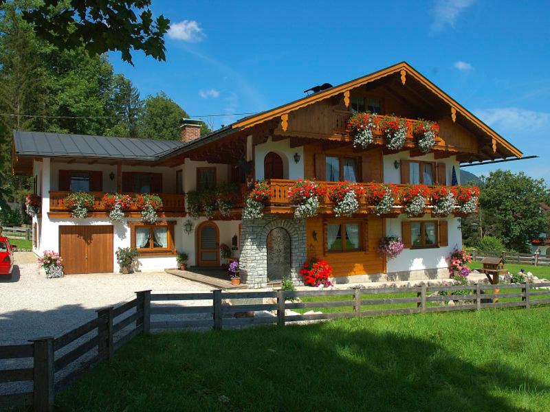 a house with flowers on the front of it at Gästehaus Freibergeck in Schönau am Königssee