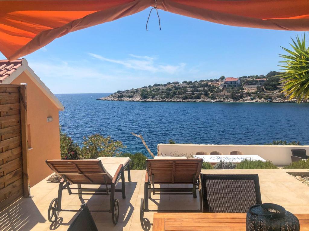 a patio with chairs and a view of the ocean at Apartment Tranquillo in Vela Luka