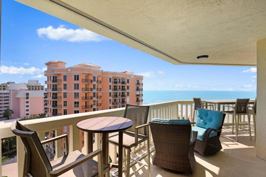 a balcony with chairs and a table and a view of the ocean at Chalet 1005 in Marco Island
