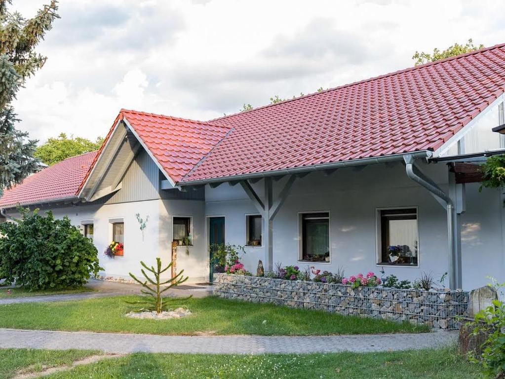 ein weißes Haus mit rotem Dach in der Unterkunft Winzerhof Düring in Iphofen