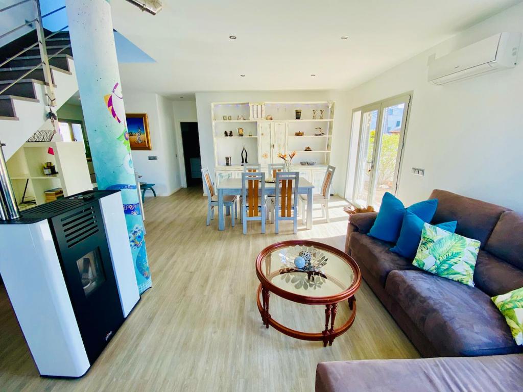 a living room with a couch and a table at Villa Isla Bonita in Sa Ràpita