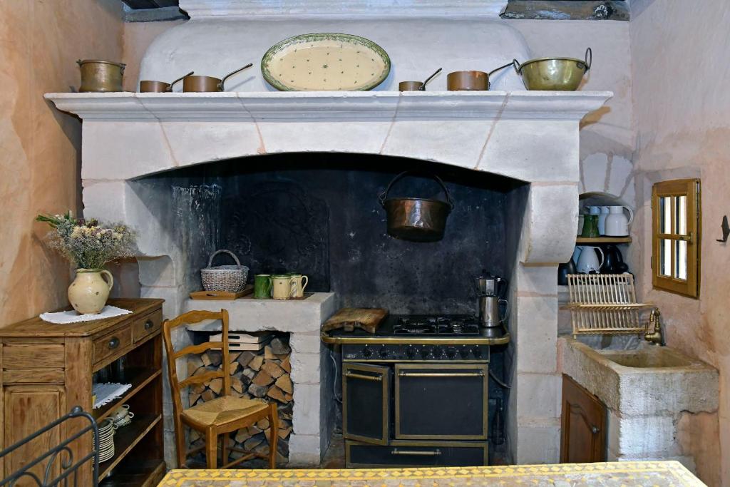 a kitchen with a stove top oven with pots and pans at Un Mas en Ville in Marseille