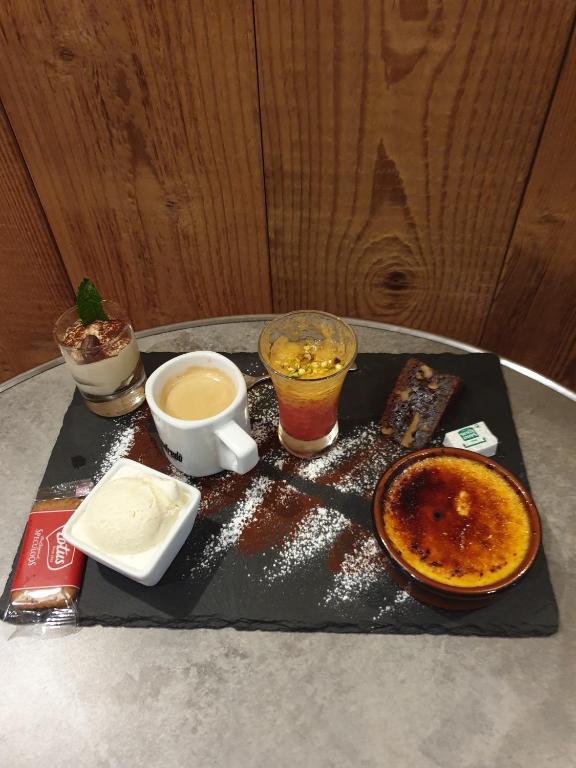 a tray with food and drinks on a table at Hotel L'alpin in Landry