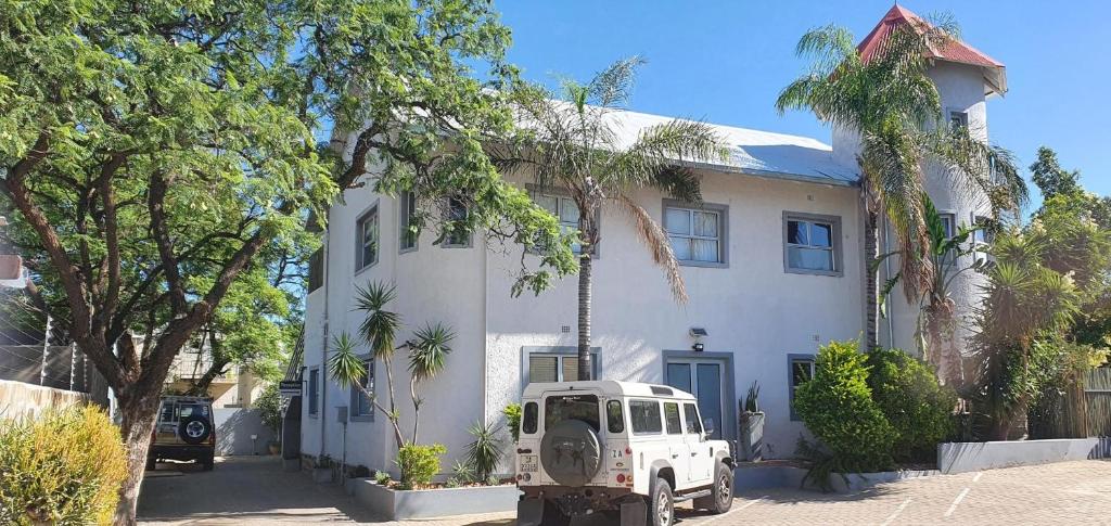 a white truck parked in front of a house at Vondelhof Guesthouse in Windhoek
