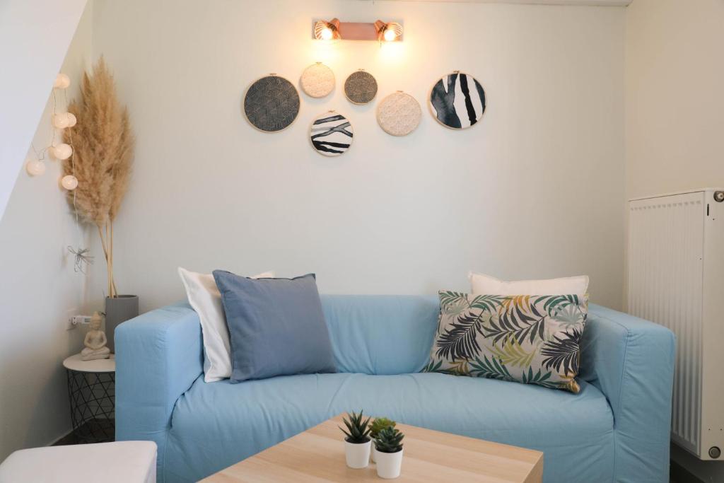 a blue couch in a living room with a table at Tramontana House2 in Skiathos