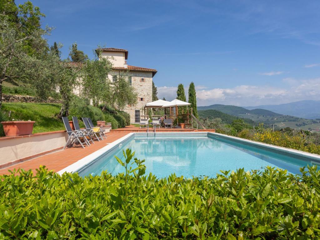 a large swimming pool in front of a house at Villa Villa Monteloro by Interhome in Ellera