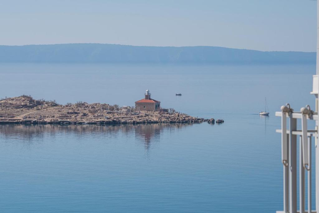 a lighthouse on an island in a body of water at Apartmani Silvija in Makarska