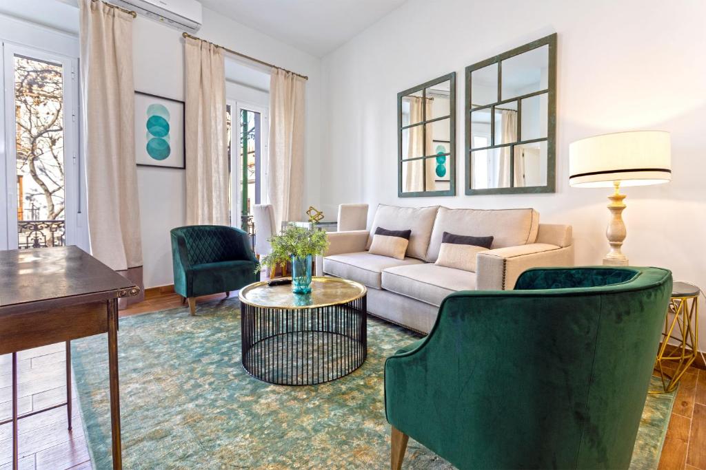 a living room with a couch and chairs and a table at Genteel Home Recaredo in Seville