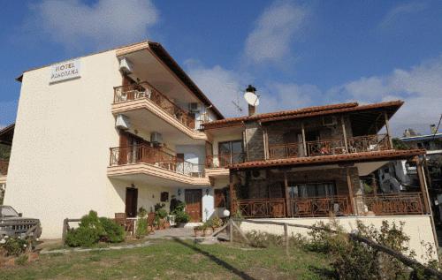 a large white building with balconies on the side of it at Panorama Spa Hotel in Ouranoupoli