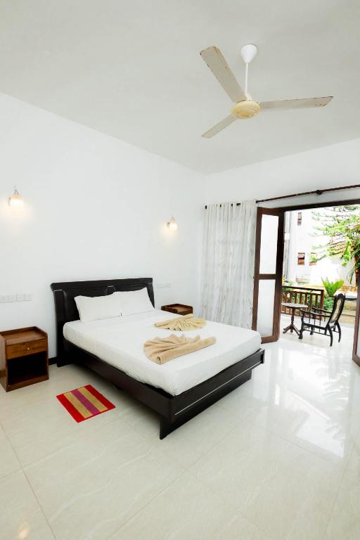 Postel nebo postele na pokoji v ubytování Hotel Neptune Bay unawatuna beach