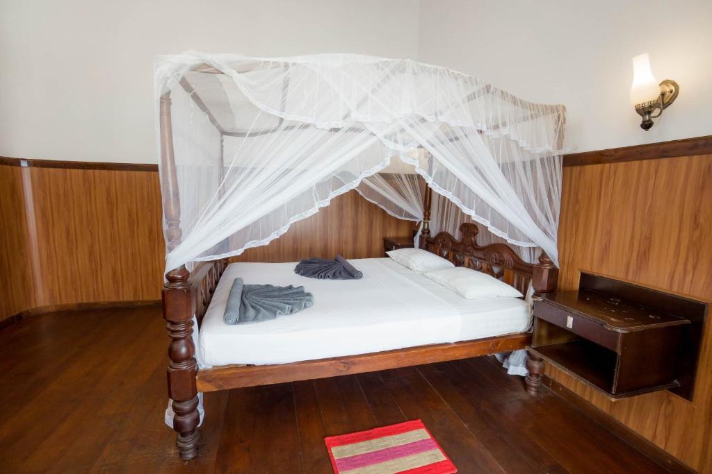 Postel nebo postele na pokoji v ubytování Hotel Neptune Bay unawatuna beach