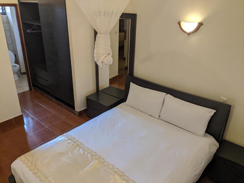 Postel nebo postele na pokoji v ubytování Prestige Hotel Suites