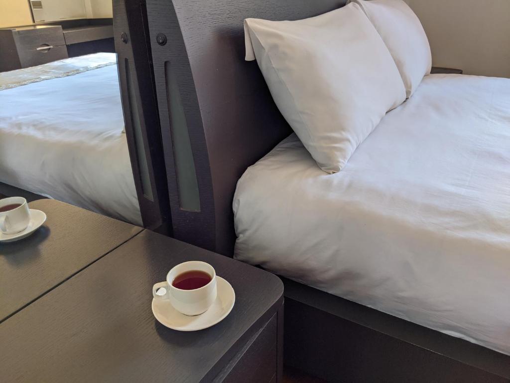 Postel nebo postele na pokoji v ubytování Prestige Hotel Suites